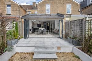 an open patio with a table and chairs at Fabulous House - Only 10 minutes walk to Roman Baths in Bath