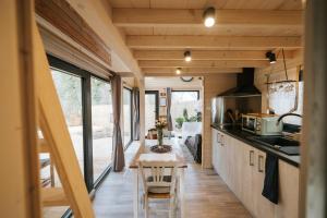 a kitchen with a table in a tiny house at Berry Séjours in Malicornay