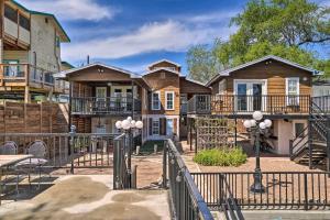 a house with a gate and a balcony at Waterfront Guadalupe River Lodge Home with Dock! in Seguin