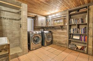 a laundry room with a washer and dryer at Waterfront Guadalupe River Lodge Home with Dock! in Seguin