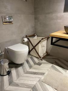 a bathroom with a toilet and a table at Anais apartment in Preveza +29 photos