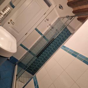 ein Bad mit blauen und weißen Bodenfliesen in der Unterkunft La Finestra Sul Corso in Montepulciano