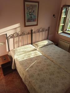 a bedroom with a large bed with a bedspread at CASA ALDEA LOS CASTAÑOS in Triongo