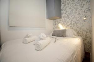 a bedroom with a white bed with towels on it at Galeon Studio in Benidorm - Near the Beach in Benidorm