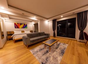 a living room with a couch and a bed at Şehrar Suite Hotel in Trabzon