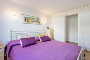 1 dormitorio con 1 cama con sábanas moradas en Villa Mercuri, en Alcudia