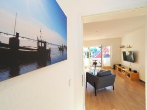 a living room with a large painting on the wall at Ferienwohnung "Sonnenblick" in Ahlbeck