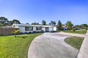 a house with a driveway in front of a yard at Merritt Island Getaway - 8 Mi to Cocoa Beach! in Merritt Island