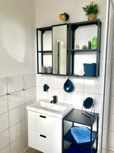 uma casa de banho com um lavatório e um espelho em Apartment Schloss Benrath em Greifswald