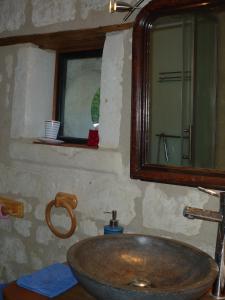 a bathroom with a sink and a mirror at Le Logis du Peu Girard in La Roche-Clermault