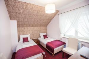 מיטה או מיטות בחדר ב-Hostel Zambrow
