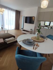 a living room with a white table and a blue chair at Luxe chalet 79 in Ružomberok