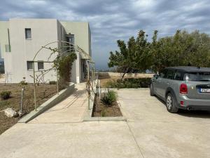 a car parked in a driveway in front of a building at Doctor's Home in Xirón Khoríon