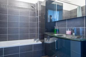 a bathroom with a sink and a tub and a mirror at SEA FRONT SUITE - Panoramic View with Terrace - 85 m in Nice +13 photos