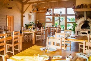 a dining room with wooden tables and chairs at Dębowa Osada in Bobolin