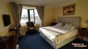 a hotel room with a bed and a window at Reddans of Bettystown Luxury Bed & Breakfast, Restaurant and Bar in Bettystown