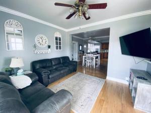 a living room with a couch and a ceiling fan at 3bed 2bath nestled in cozy Grandview neighborhood in Dubuque