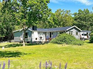 a house in a field with purple flowers in front of it at 6 person holiday home in STURKÖ-By Traum in Sturkö