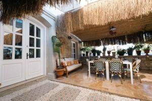 patio con mesa, sillas y puerta blanca en Mono Lıfe Alaçatı, en Alacati