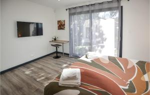 - une chambre avec un lit et une télévision à écran plat dans l'établissement Nice Home In Colonzelle With Wifi, à Colonzelle