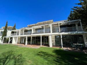a large white house with a lawn in front of it at Casa Do Mar - Sea View Beach House - Troia Comporta in Troia