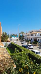 a street with cars parked in a parking lot at Casa Playa Javea in Jávea