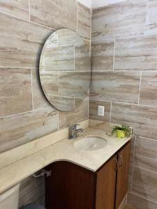 a bathroom with a sink and a mirror at Finca La Maria: Recreo y naturaleza (22 personas) in Santa Fe de Antioquia