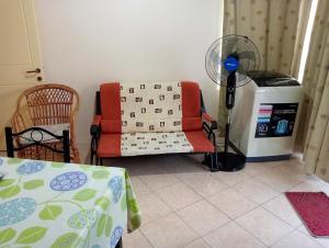 a living room with a couch and a fan at One bedroom appartement at Pereybere Grand Baie 350 m away from the beach with enclosed garden and wifi in Pereybere