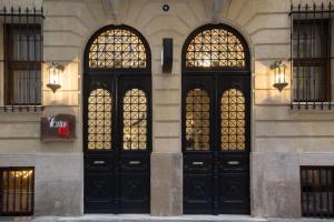 three black doors on the side of a building at Taxim Lounge Hotel Special Category in Istanbul