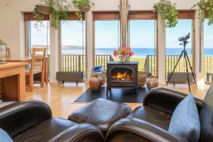 a living room with a couch and a fireplace at Broad Bay House in Stornoway