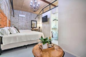 a bedroom with a bed and a table with a potted plant at Laredo Vacation Rental Near Tourist Attractions! in Laredo