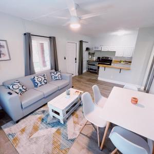 a living room with a couch and a table at The Leeward Apartments By Lowkl in Fort Lauderdale