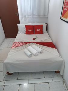 a bed in a room with two pillows on it at Pousada Torre dos Mouros in Pirenópolis