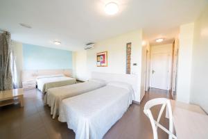Postel nebo postele na pokoji v ubytování Hotel La Colina