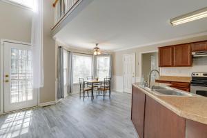 a kitchen with a sink and a table at Stone Mountain Vacation Rental with Deck! in Stone Mountain