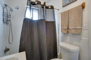 a bathroom with a shower curtain and a toilet at Pet-Friendly Vacation Rental Near Boyd Lake! in Loveland +16 photos