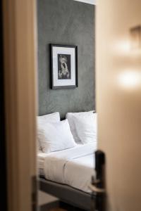 a bedroom with a bed with a picture on the wall at Weber Hotel 397 in Amsterdam