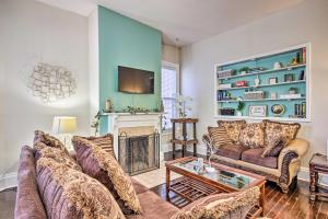 a living room with a couch and a fireplace at Bright Augusta Vacation Rental, 2 Mi to Riverwalk! in Augusta