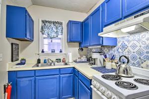 a kitchen with blue cabinets and a stove top oven at Bright Augusta Vacation Rental, 2 Mi to Riverwalk! in Augusta