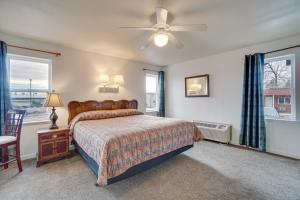 a bedroom with a bed and a ceiling fan at Loveland Vacation Rental Near Downtown! in Loveland