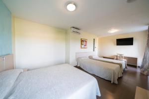 Postel nebo postele na pokoji v ubytování Hotel La Colina