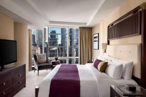 a hotel room with a large bed and a large window at Shangri-La Toronto in Toronto
