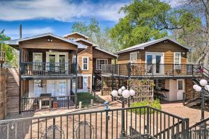 a house with balconies and a fence at Guadalupe River Cottage with Direct Lake Access! in Seguin