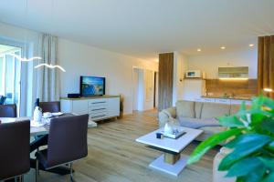 a living room with a couch and a table at Haus Nordseebrandung NC24 in Cuxhaven