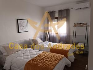 a bedroom with two beds and a star on the wall at Casa dos Andrades in Belmonte