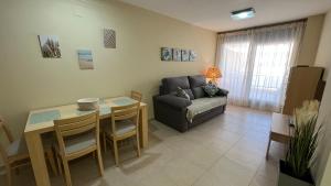 a living room with a couch and a table at Sueños del Mar 1 By Alquileres El Conserje in Denia