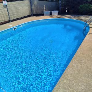 a large blue swimming pool with blue water at Shady Acre Inn and Suites in Branson West