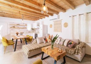 a living room with a couch and a table at Villa Pagona in Pitsidia