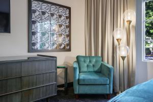 Venezia في ميامي بيتش: غرفة نوم مع كرسي أزرق وخزانة
