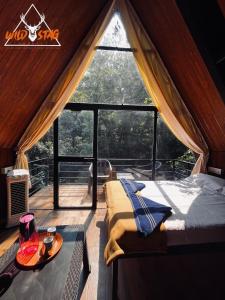 a bedroom in a tent with a bed and a table at WildStag Dandeli in Dandeli